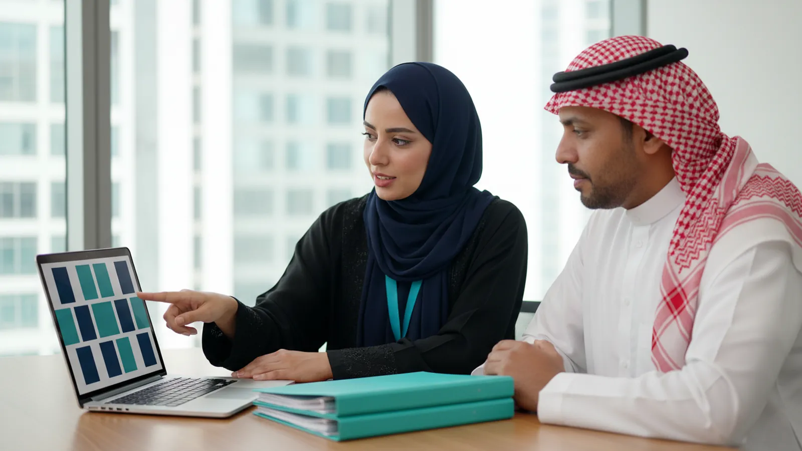 An HR consultant reviews the payroll summary and employee files with a company owner